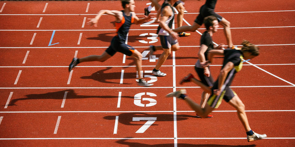 athletes crossing finish line after sprint race